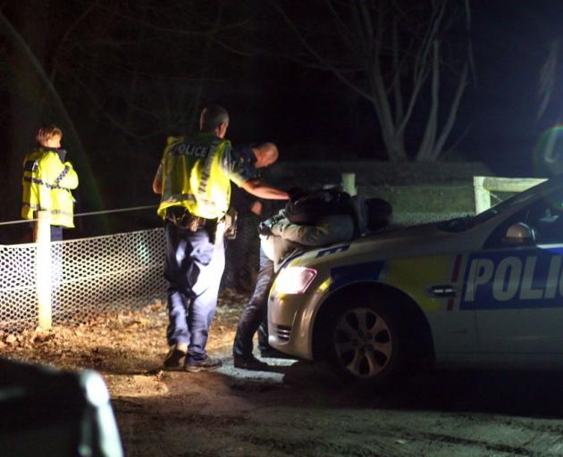 A man is detained after a police chase in the Queenstown area last night. Photo by Blair Pattinson