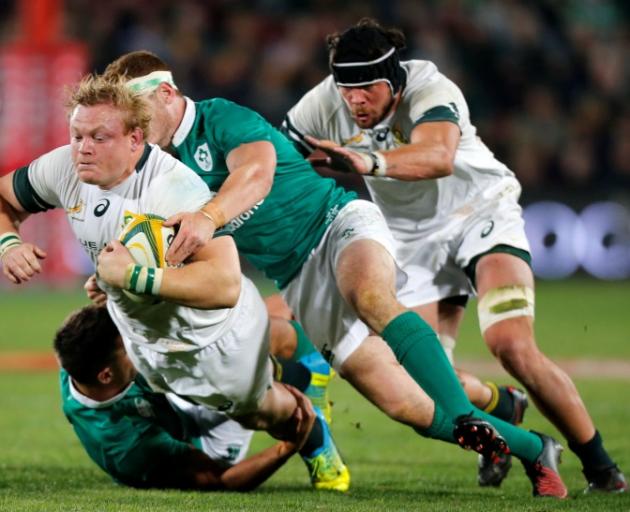 Adriaan Strauss (left) is tackled by Ireland's Paddy Jackson. Photo: Reuters