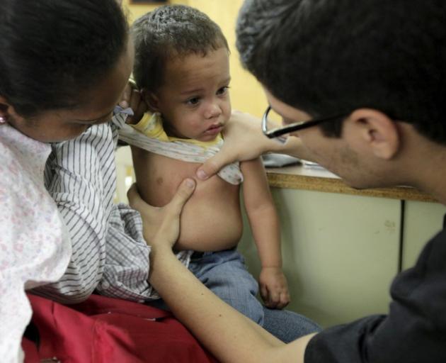A child suspected to be infected is examined  at a hospital in Caracas, Venezuela. Photo: Reuters 