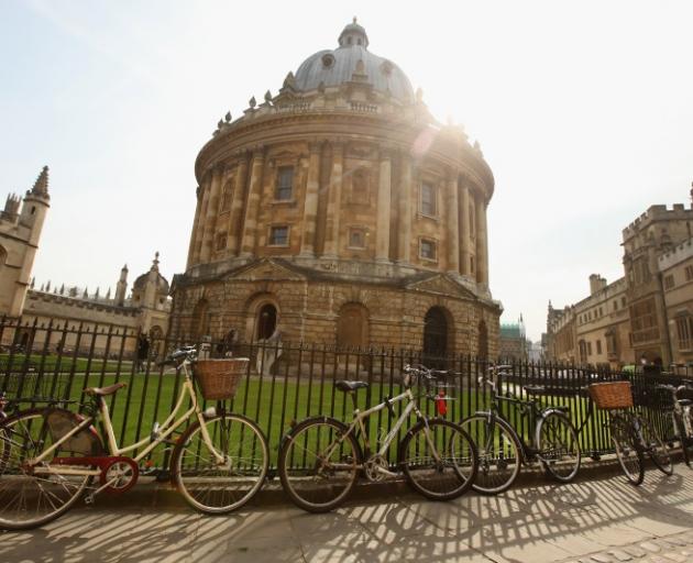 Bikes are chained to the railings in front of the Radcliffe Camera building in Oxford, England. Rather than being a minority mode of transport, bikes in Oxford are highly visible. Photo: Getty Images