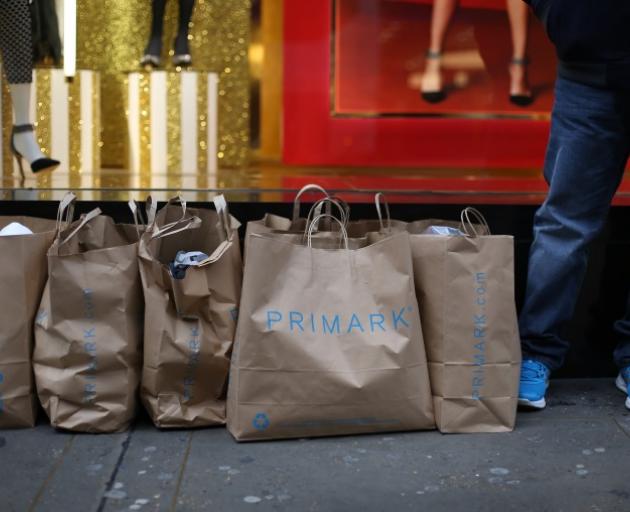 A customer waits with purchases outside fast-fashion retailer Primark's flagship Oxford St store. Photo: Getty Images 