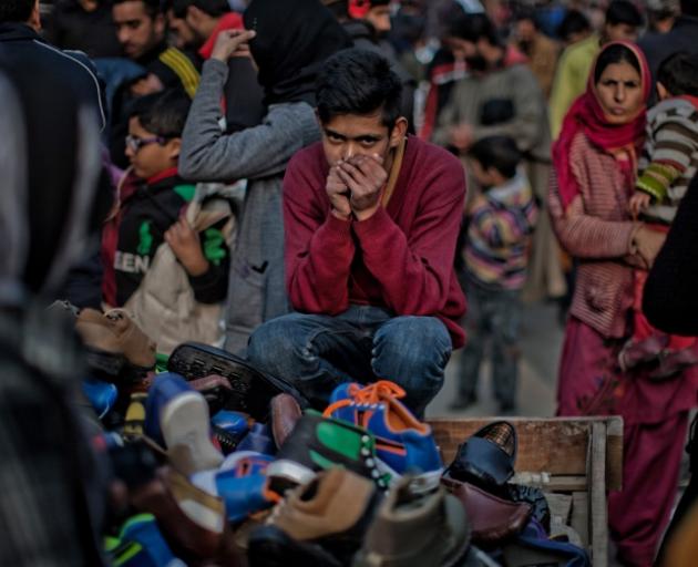 A Kashmiri child vendor sells shoes from a cart on the roadside in Srinagar. India has 4.35 million child labourers, aged 5 to 14, with rampant cases of slavery, sexual assault and emotional abuse. Photo: Getty Images 