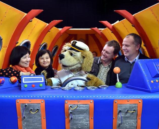 ZooMoo children's television show character Flash, the dog, with Chinese Central Television producers (from left) Yang Chao and Zong Ying, and ZooMoo creative director Ian McGee and NHNZ  managing director Kyle Murdoch (right). Photo by Peter McIntosh. 