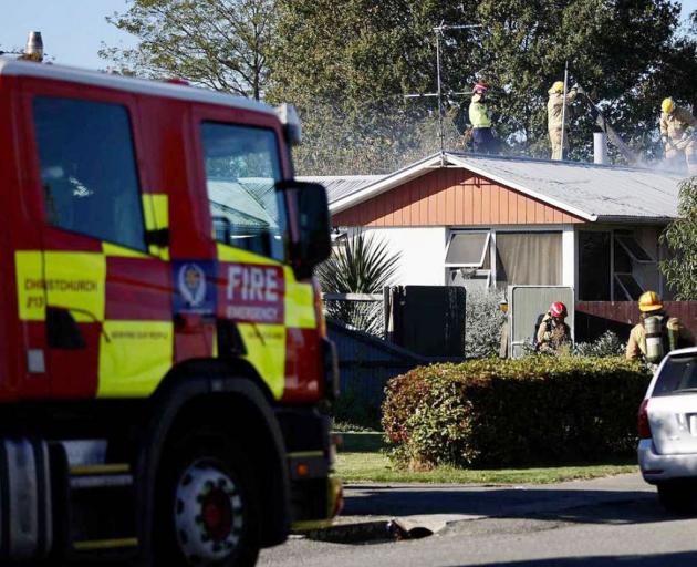 Fire crews battle the house fire in Kaiapoi. Photo: George Heard