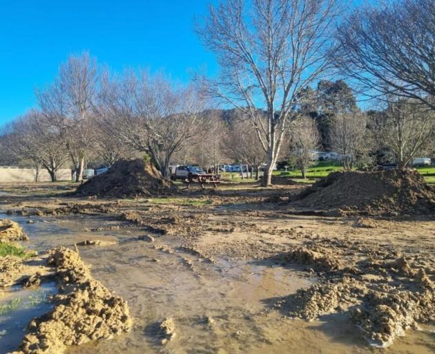 Flooding left 150mm of mud across Bethany Park Campground in 2025. Photo: RNZ