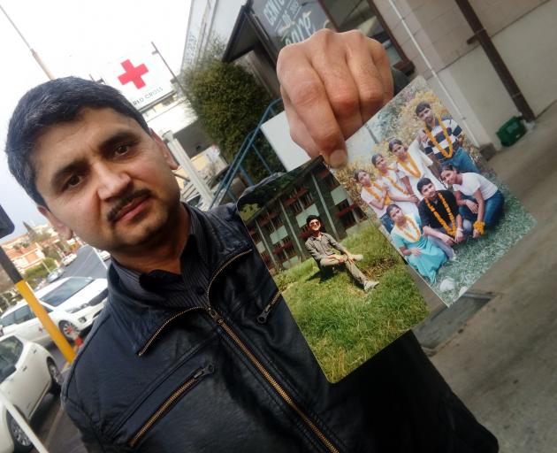 Former refugee and now refugee adviser Govinda Regmi, of Dunedin, holds rare photos of (from left...