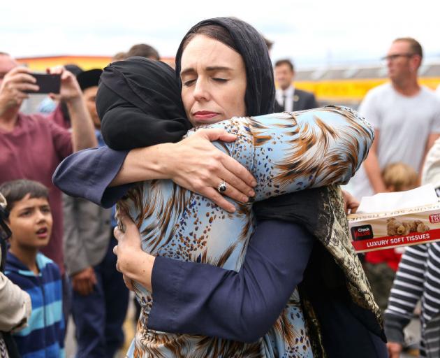 Jacinda Ardern hugs a Muslim woman during a visit to a Wellington mosque after the attacks in...