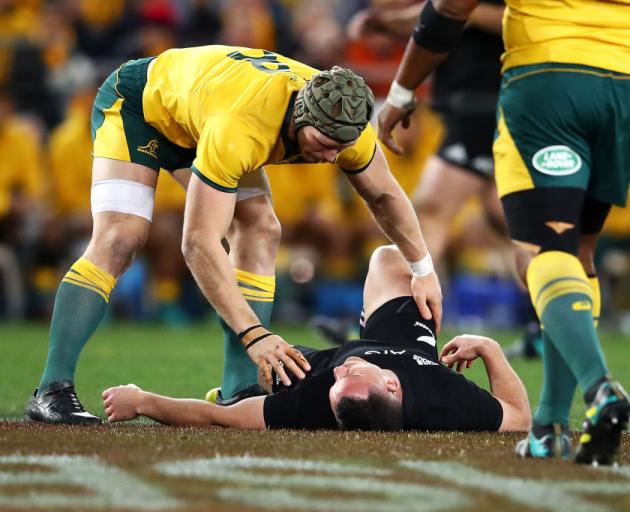 Wallaby David Pocock checks on Ryan Crotty after he was knocked down early in the match. Photo:...