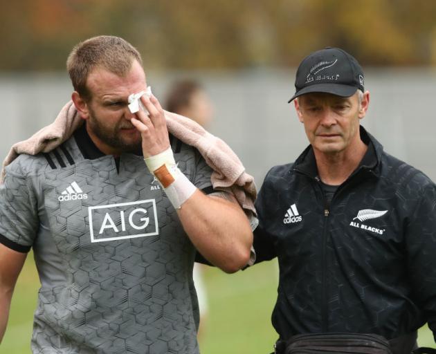 Joe Moody is assisted by Dr Tony Page after suffering a bad cut to his eye during training...