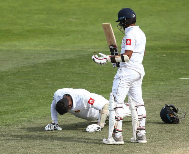 Angelo Mathews celebrates his century with a set of push-ups watched by Kusal Mendis. Photo:...