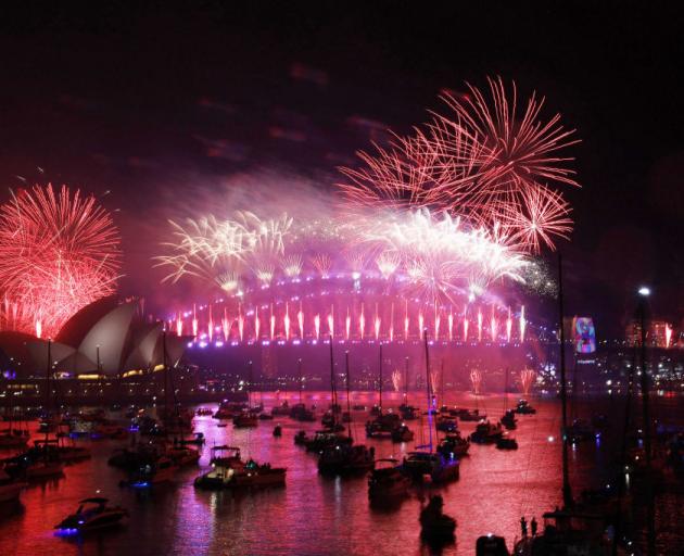 Fireworks explode over the Sydney Harbour Bridge during the New Year's celebrations on January 1...