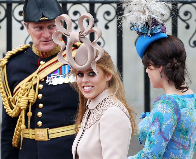 Princess Beatrice with her sister Princess Eugenie. Her controversial fascinator was later...