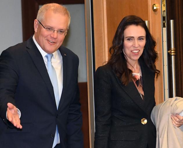 Australian Prime Minister Scott Morrison accompanies New Zealand Prime Minister Jacinda Ardern...