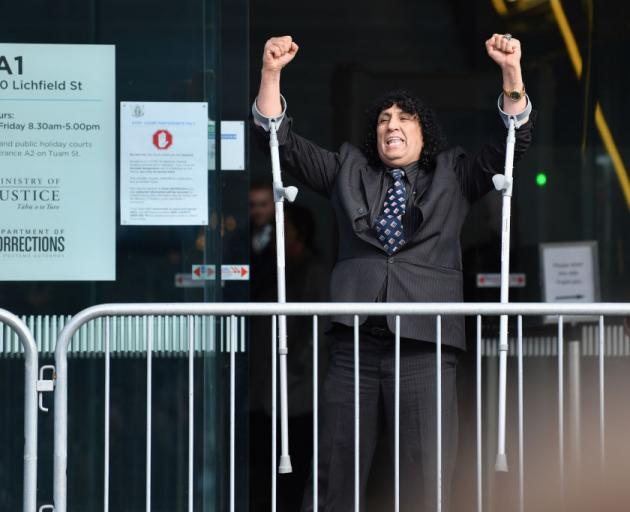 Al Noor Mosque shooting survivor Taj Mohammad Kamra celebrates as he leaves the High Court this...