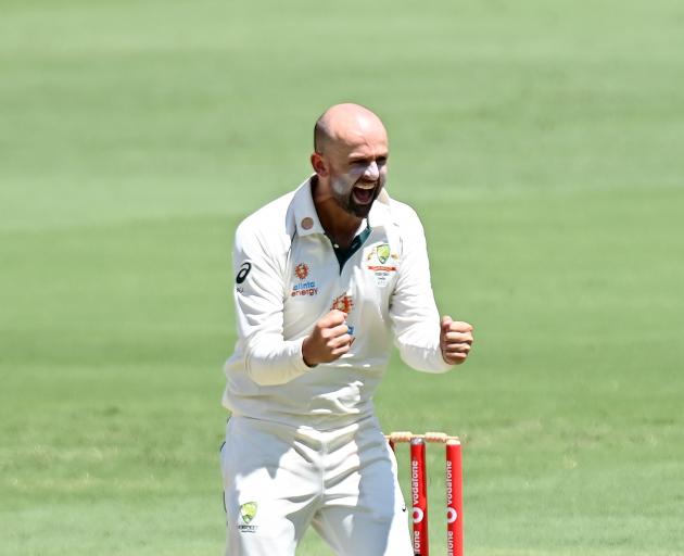 Nathan Lyon celebrates taking the wicket of Indian batsman Shubman Gill during the fourth test at...