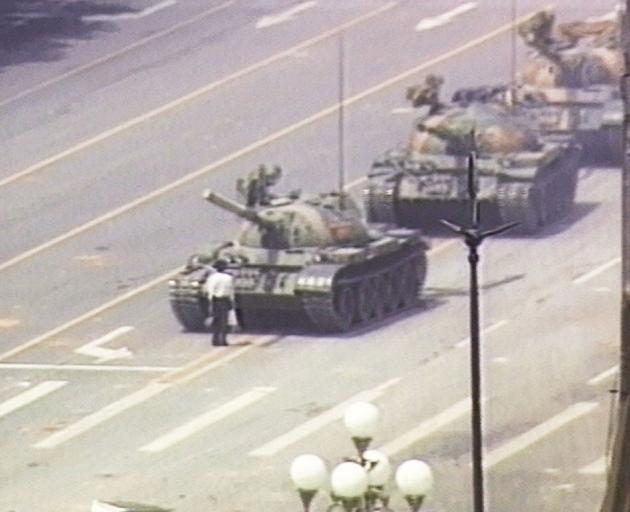 In this famous image, a lone demonstrator stands down a column of tanks at the entrance to...