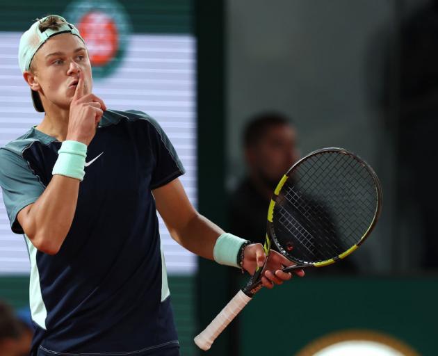 Bolger Rune, of Denmark, gestures to the crowd for silence during his quarterfinal against...