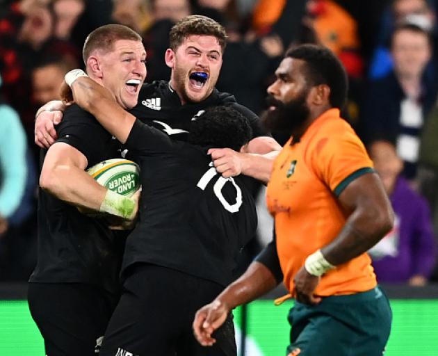 Jordie Barrett celebrates after scoring the winning try with Dalton Papali’i and Richie Mo’unga....