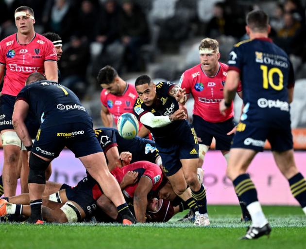 Aaron Smith clears the ball for the Highlanders during Saturday's match. The team went on to win...