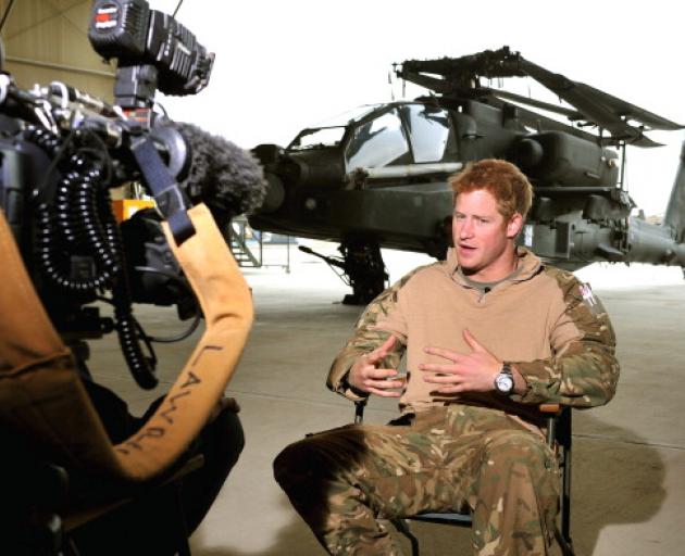 Prince Harry gives a TV interview in an Apache repair hanger at Camp Bastion. Photo: Getty Images