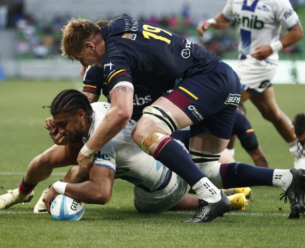 Hoskins Sotutu scores one of his three tries for the Blues against the Highlanders in Melbourne...