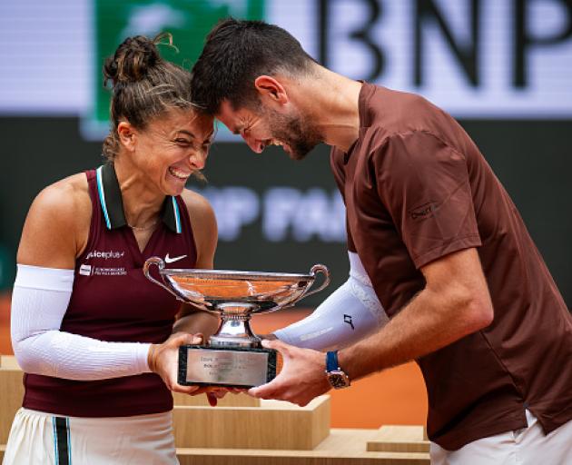 Italians Sara Errani Andrea Vavassori pose with the champions trophy after defeating Americans...