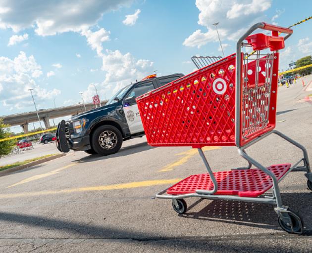 An empty Target basket is seen near the grounds of a Target store on August 11, 2025 in Austin,...