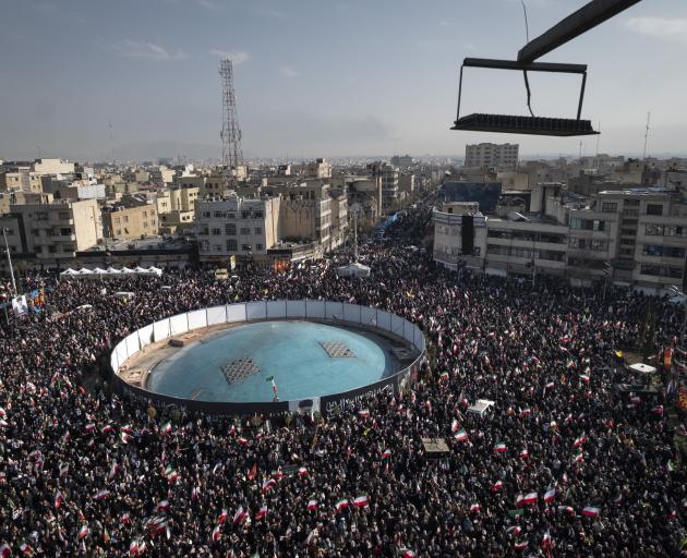 Crowds wave national flags and participate in a rally to pledge allegiance to Iran's new Supreme...