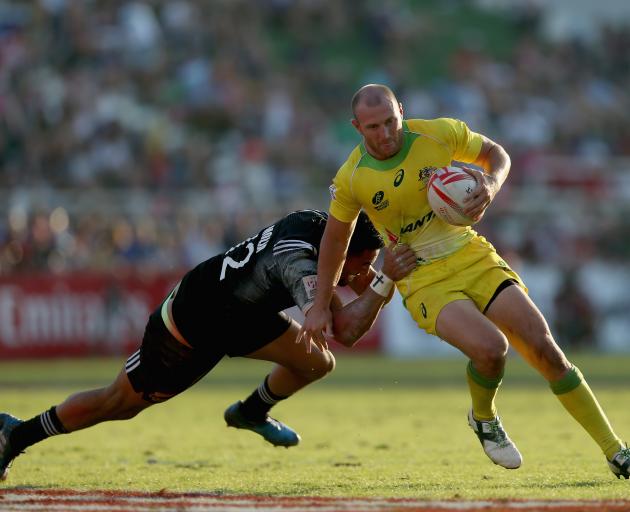 New Zealand's Sione Molia (left) makes a tackle on James Stannard from Australia. Photo: Getty...