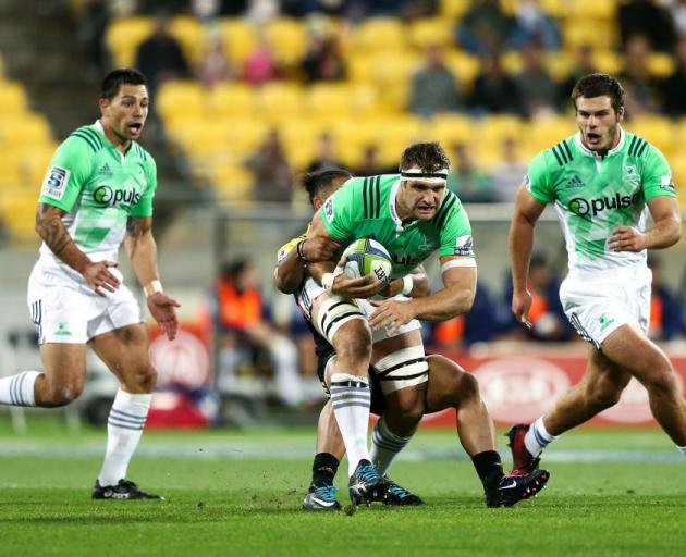 Highlanders No 8 Luke Whitelock carts the ball up in the tackle of Hurricanes centre Matt Proctor while in support is second five-eighth Rob Thompson (left) and flanker Dillon Hunt. PHOTO: GETTY IMAGES