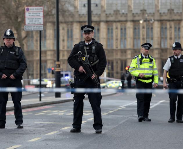 Armed officers guard the area outside Westminster Bridge and the Houses of Parliament. Photo: Getty Images 