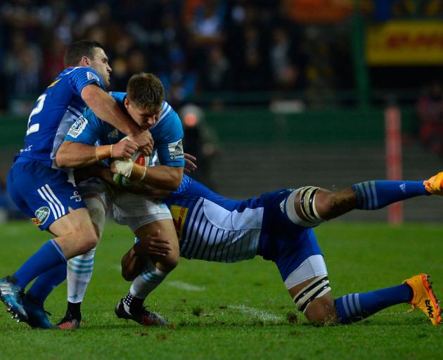 Blues player Piers Francis is tackled by Shaun Treeby and Nizaam Carr. Photo: Getty Images