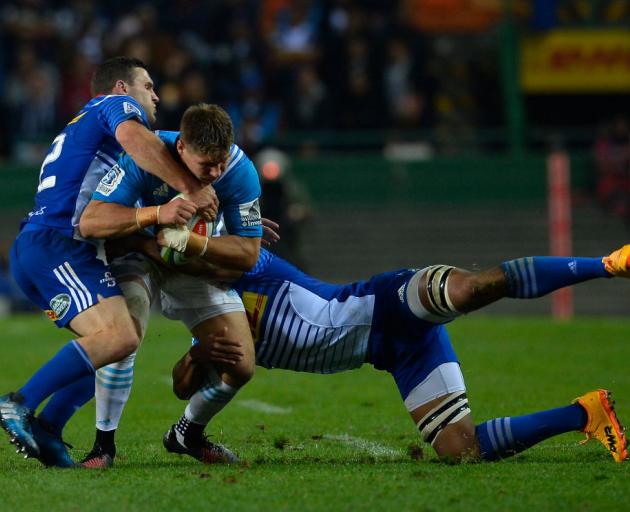 Blues player Piers Francis is tackled by Shaun Treeby and Nizaam Carr. Photo: Getty Images 