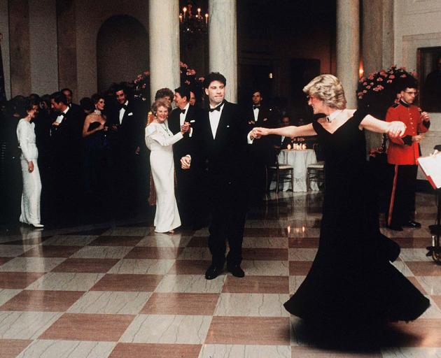 Diana, watched by First Lady Nancy Reagan, dances with John Travolta in the Victor Edelstein...