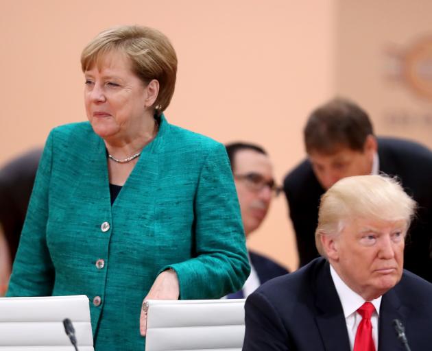German Chancellor Angela Merkel (left) and US President Donald Trump attend a morning working...
