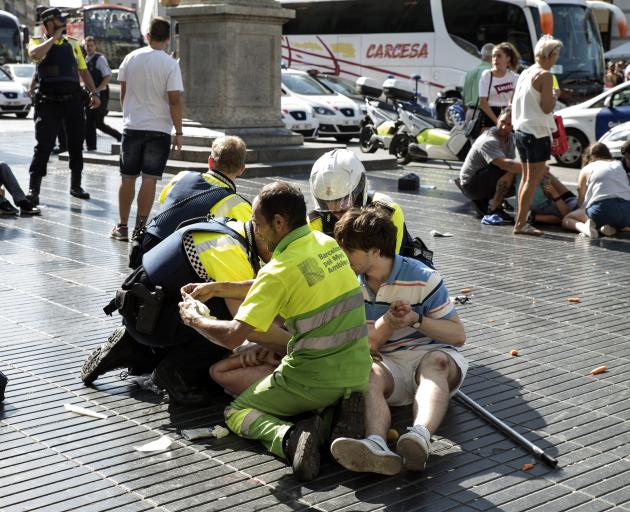 Medics and police tend to injured after the attack in central Barcelona. Photo: Getty Images 