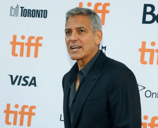 George Clooney's poem follows days of attacks by Donald Trump on NFL players who kneel during the playing of the US national anthem to protest racial disparities in the justice system. Photo: Getty Images 