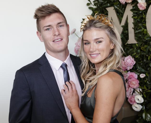 Adam Tomlinson and Amy Pejkovic attend the Moet and Chandon Spring Champion Stakes Day at Royal...