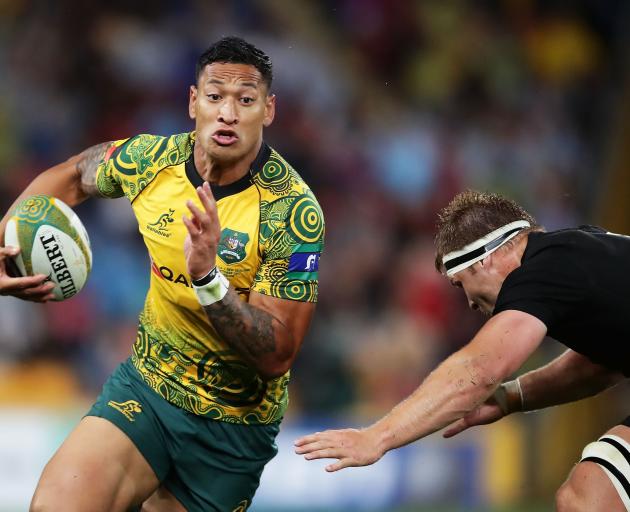 Israel Folau eludes a tackle during the Wallabies' win against the All Blacks in Brisbane on Saturday. Photo: Getty Images 