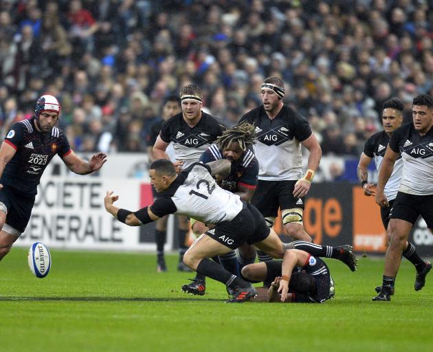 Sonny Bill Williams (centre) drops the ball as he is tackled by Mathieu Bastareau at Stade de...