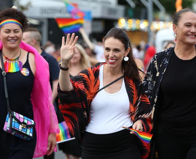 Jacinda Ardern (centre) waves to the crowd lining Ponsonby Rd. Photo: Getty Images 