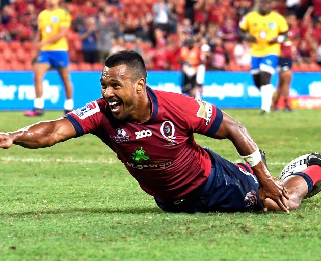 Aidan Toua celebrates scoring a try for the Reds in Brisbane. Photo: Getty Images 