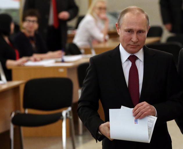 Vladimir Putin at a polling station in Moscow at the weekend. Photo: Getty Images 