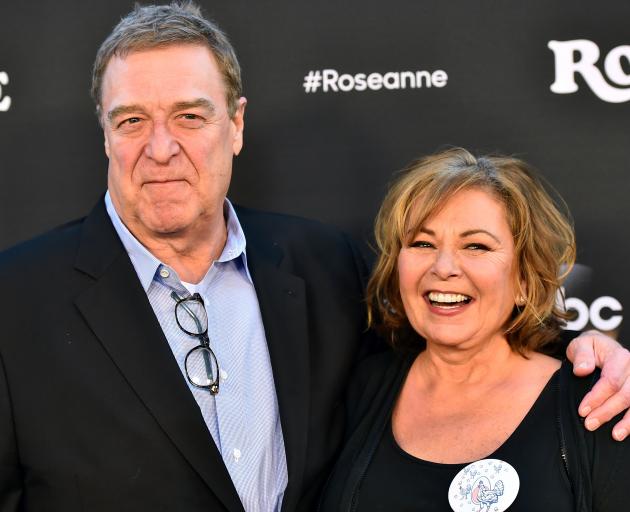 Roseanne Barr with John Goodman, who played her on-screen husband. Photo: Getty Images