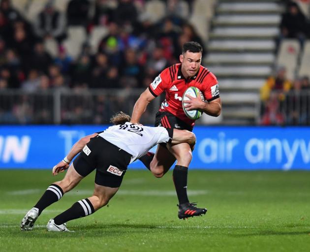 Ryan Crotty of the Crusaders charges over a Sunwolf at AMI Stadium. Photo: Getty Images 