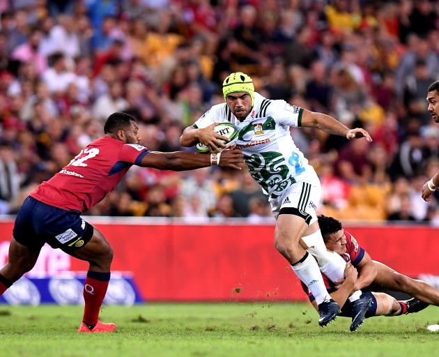 Charlie Ngatai tries to break through the Reds' defence. Photo: Getty Images 