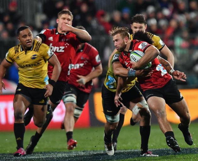 Braydon Ennor is tackled by Ardie Savea in an earlier Super Rugby clash between the Crusaders and...