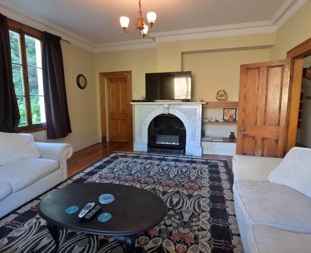 A handsome white marble fireplace is a feature of the front room. 