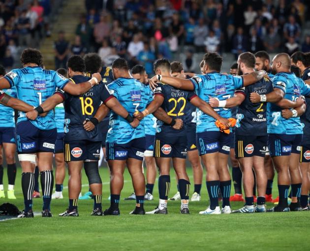 Highlanders and Blues players linked arms to honour the Christchurch mosque victims before the...