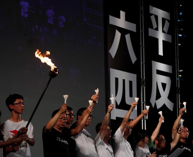 Pro-democracy activists at a candlelight vigil at Victoria Park in Hong Kong. Photo: Reuters 